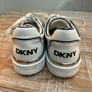 DKNY womens stylish black white and chrome detailed sneakers. Size 8 med.